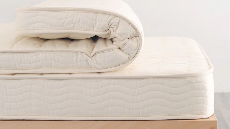 Close-up of a rolled-up mattress topper