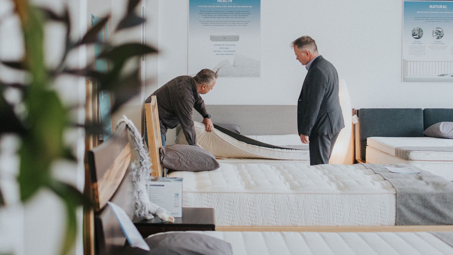 man thoroughly checking the mattress