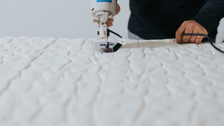 Mattress being cut with a specialized tool