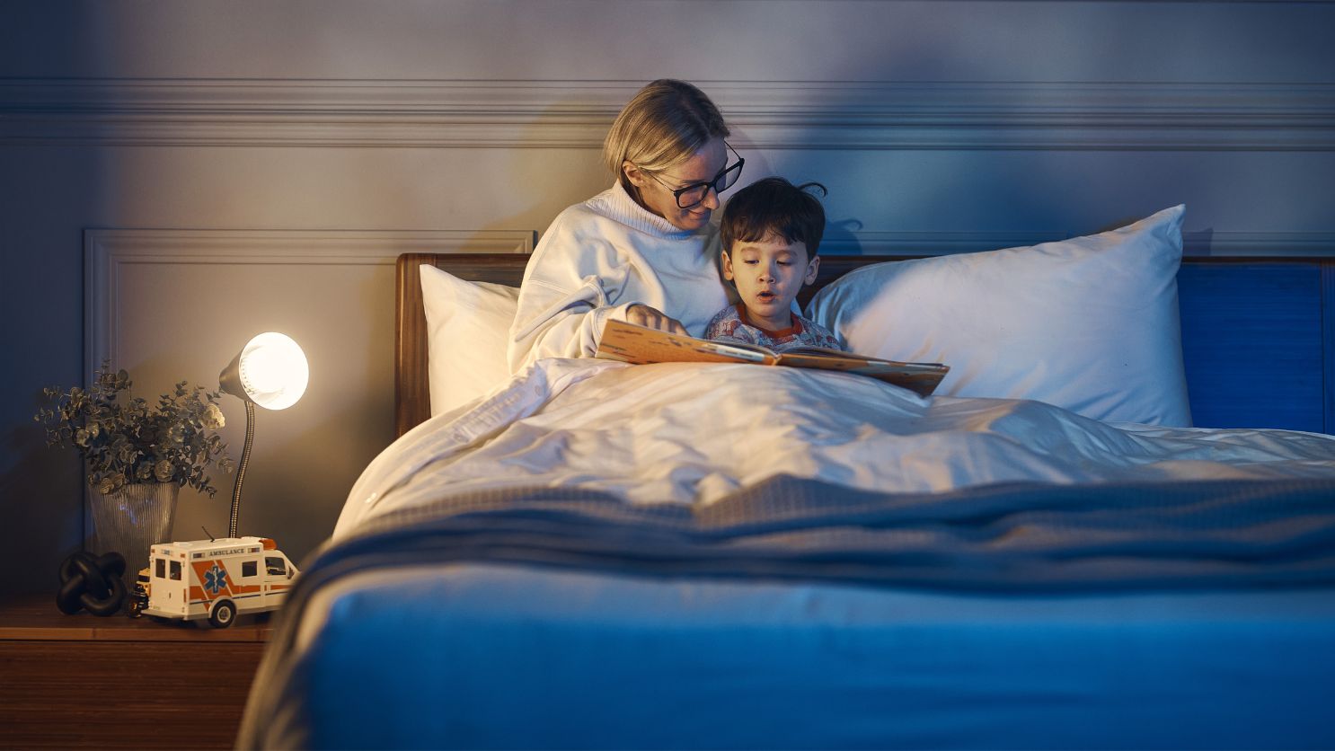 woman reading bedtime stories to her son